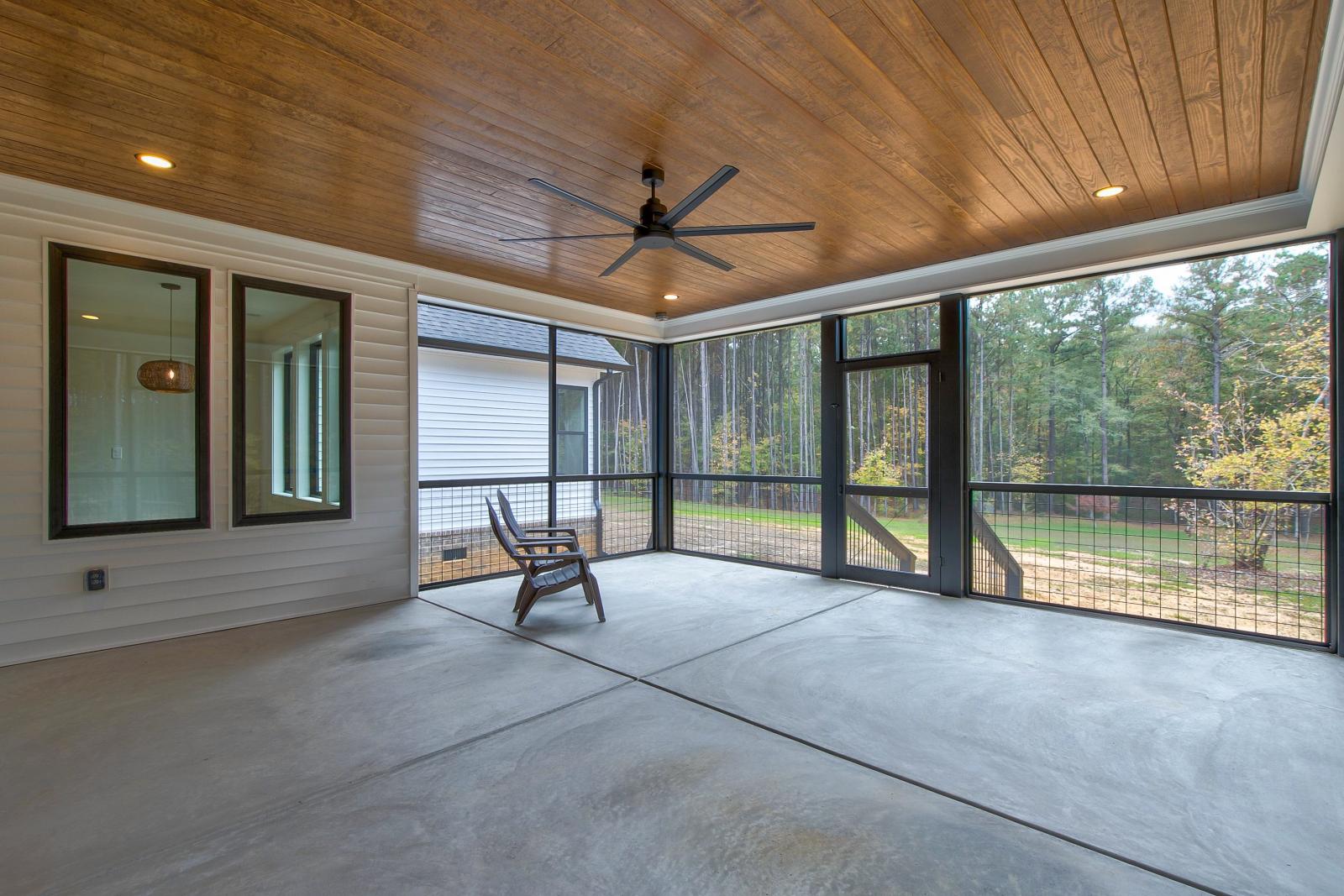 Screened back porch with wood ceiling and ceiling fan